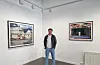 Fotograf Erlend Berge står framfor fotoutstillinga si «Kjære alle saman!». I sju år har han tatt bilde av norske talarstolar. Foto: Kenneth Sjøvold / NPK