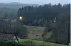 Utsikt frå vindauget i andre etasje på garden Berge. Hjortekalven låg bak treet til venstre i biletet, midt mellom gatelyktene. Garden Berge ligg på høgre side av E39 når ein køyrer nordover, og like før Liereidkrysset.