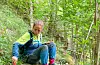 Fride Høistad Schei på feltarbeid i eit skogsområde. Foto: Robert Lewis / Nibio